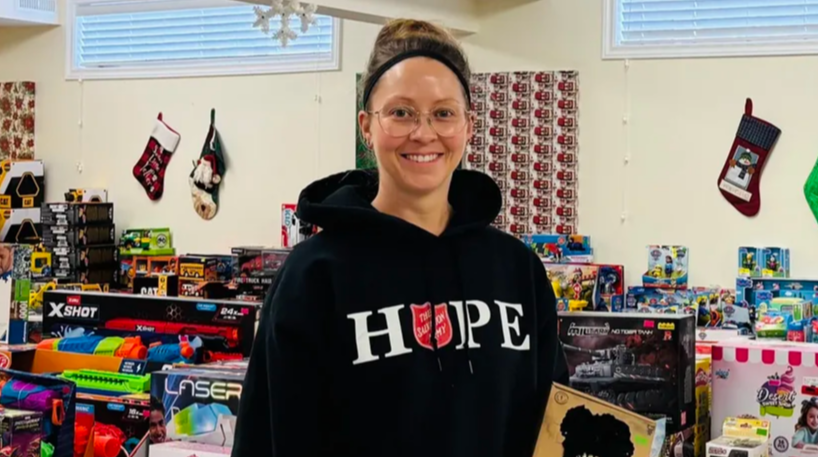 Woman holding a toy and smiling