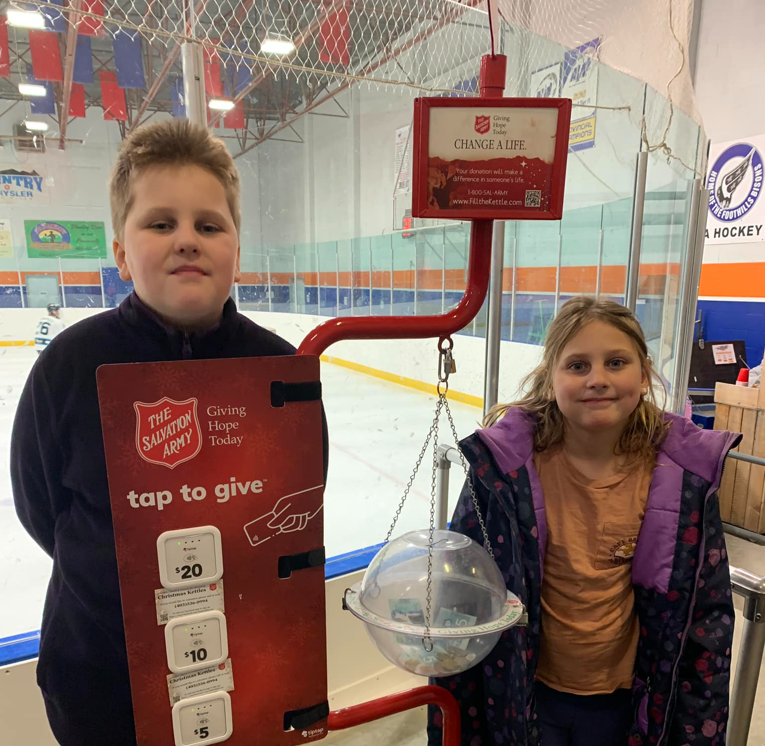 Two kids volunteering for the Christmas Kettle campaign
