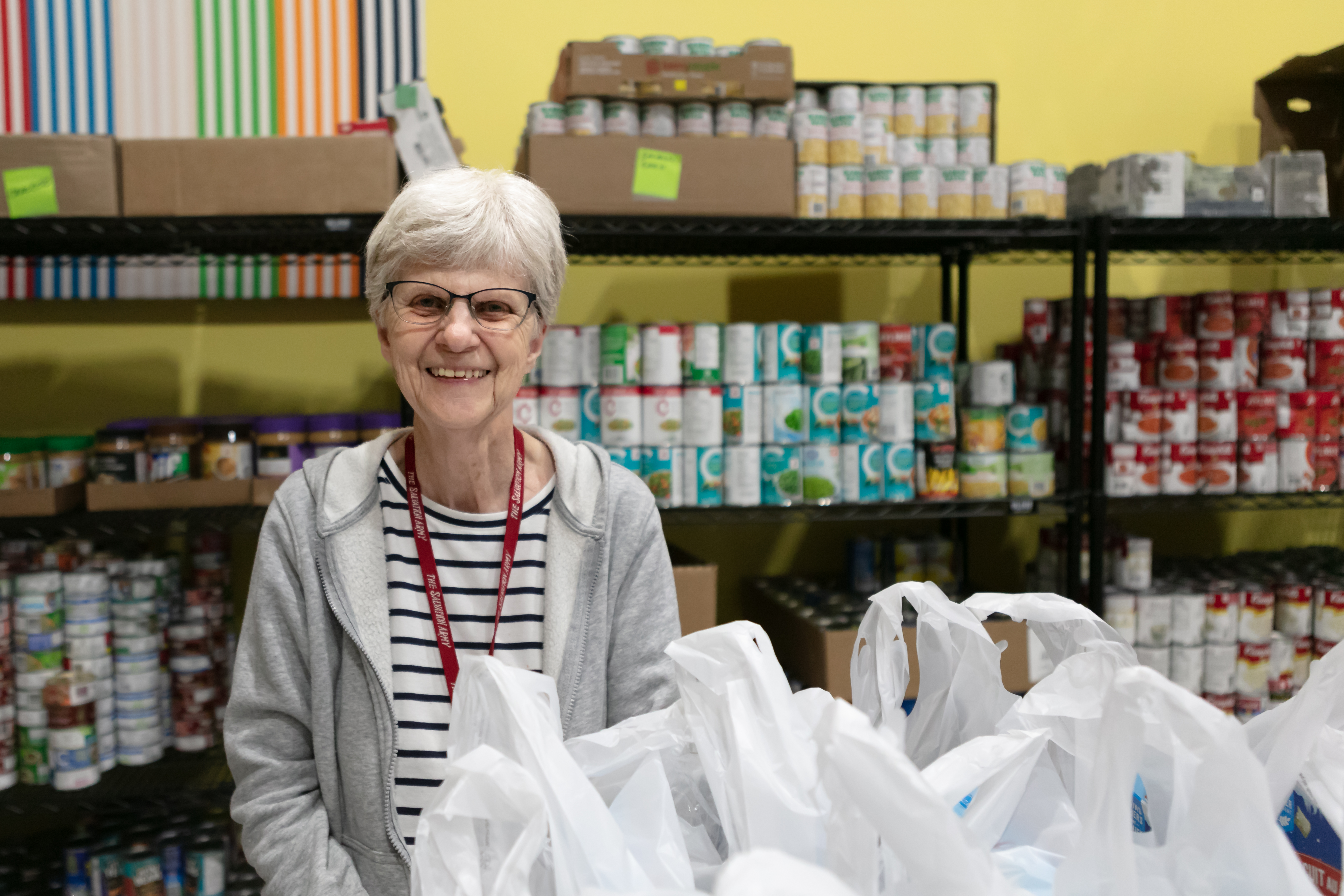 A thrift store employee smiling at the camera