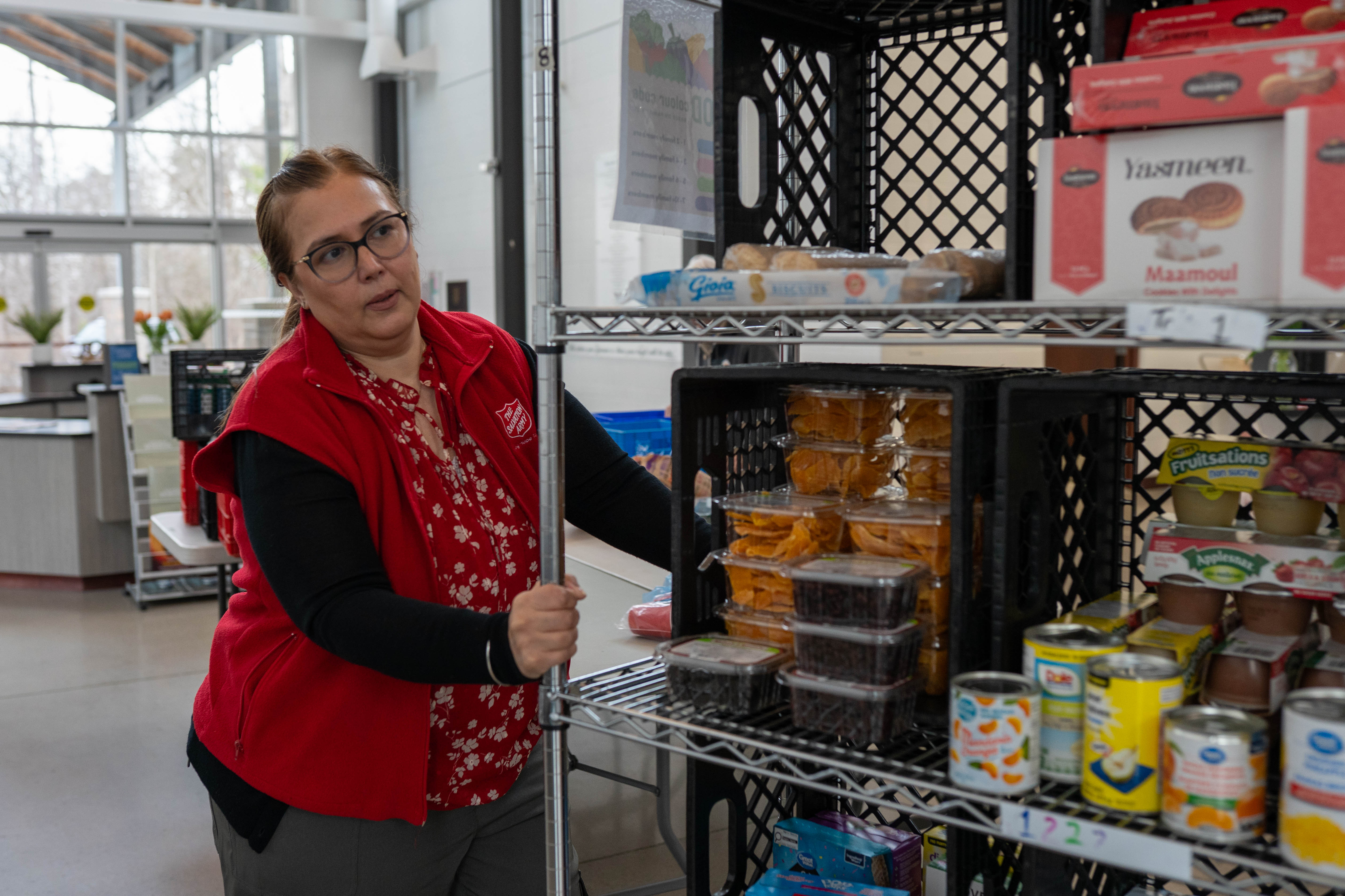 A volunteer helping sort food donations