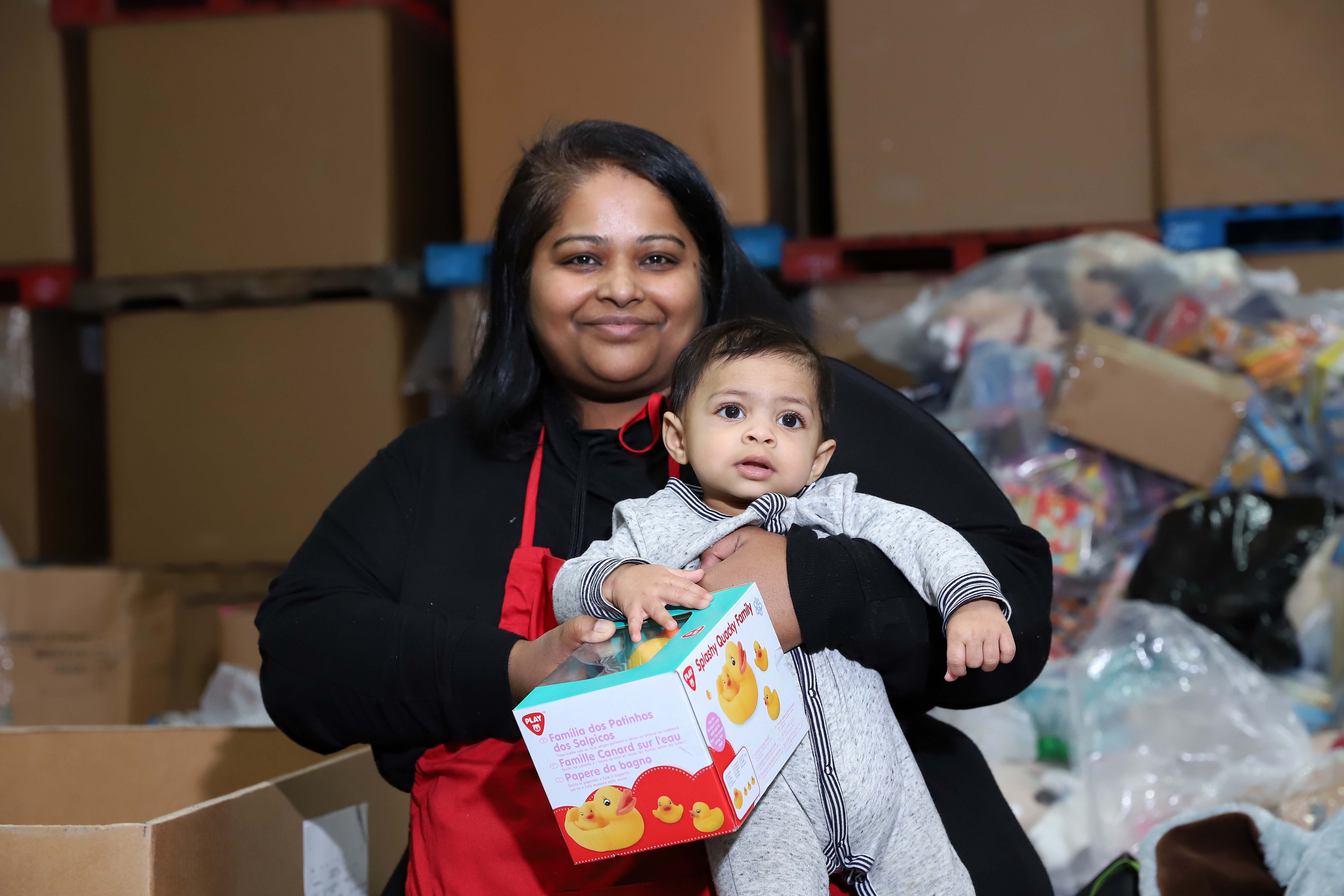 A baby being held by her mother.