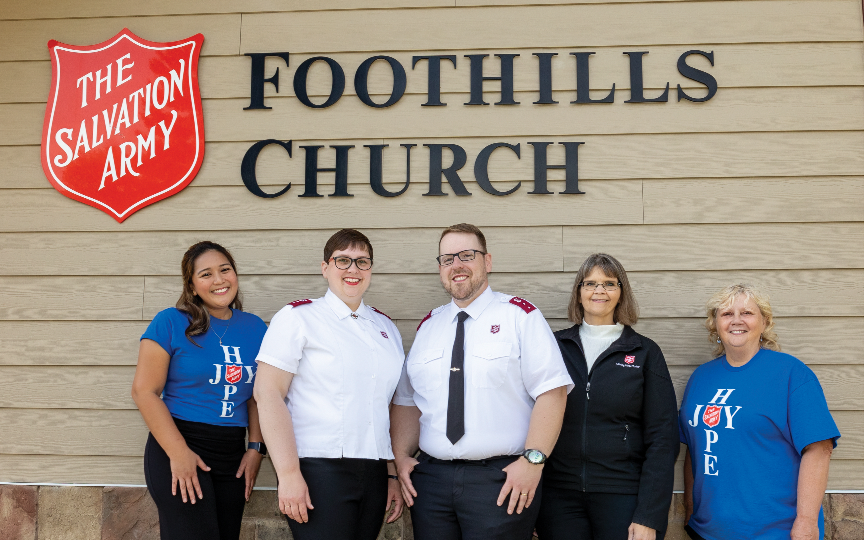 Foothills management team under church sign
